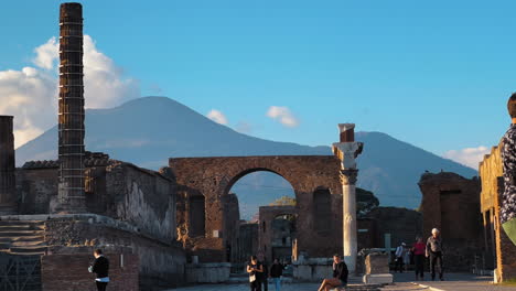Time-lapse-shot-of-tourist-visiting-old-archaeological-site-in-Pompeii-and-clouds-covering-MOunt-Vesuvius
