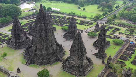 Hindu-temple-Prambanan-in-Yogyakarta,-Indonesia-during-humid-conditions,-Aerial-pedestal-rising-shot