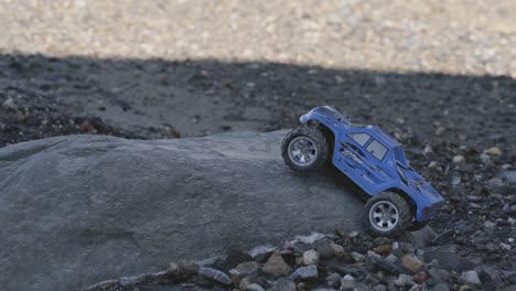 Remote-control-vehicle-on-rock,-blue-color