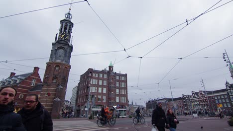 Munttoren-clock-tower-in-downtown-Amasterdam,-Holland,-Muntplein-street,-Wide-shot-4K