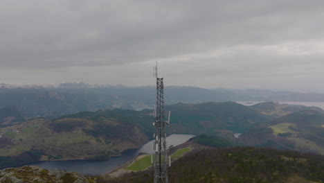 Drone-shot-orbiting-5G-telephone-Mast-in-mountain-nature-landscape,-Norway