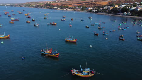 Aerial-view-of-fisherman-village-in-harbor-mui-ne-Vietnam-Asia,-drone-fly-above-boat-for-fishing-in-remote-coastline-town