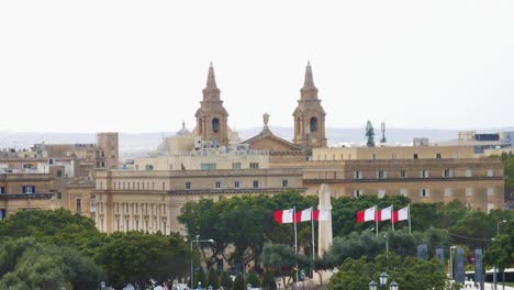 Historical-Maltese-building-with-church-towers-behind-in-Valletta,-static-view