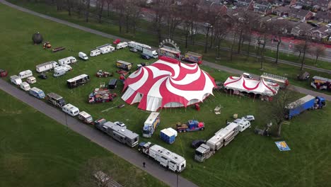 Planet-circus-daredevil-entertainment-colourful-swirl-tent-and-caravan-trailer-ring-aerial-view-faster-zoom-in