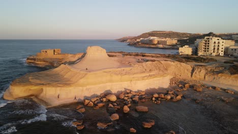 A-cinematic-view-of-the-Xwejni-salt-pans-towards-the-yellow-Xwejni-rock-on-the-island-of-Gozo-in-Malta