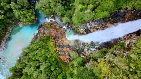 Overhead-view-of-the-Rio-Blanco-waterfall-surrounded-by-the-forest-of-Hornopiren-National-Park,-Chile