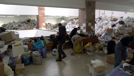 Volunteers-sort-through-bags-of-donated-clothing-in-the-Art-Palace-of-Lviv-that-has-been-converted-into-the-largest-aid-centre-in-the-region-during-the-Russian-war-against-Ukraine