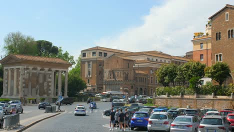 Shot-of-traffic-movement-beside-Basilica-di-Santa-Maria-or-Schola-Graeca-which-is-a-minor-church-in-Rome-located-in-Mouth-of-Truth-square-or-Piazza-Bocca-della-Verita-in-Rome,-Italy
