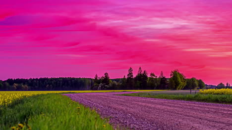 Empty-Dirt-Road-On-Countryside-Against-Fiery-Red-Sunset-Sky
