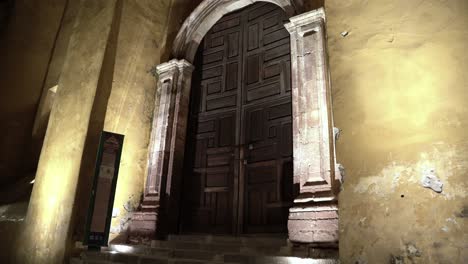 A-huge-wooden-door-with-dull-paint-on-the-all-at-night