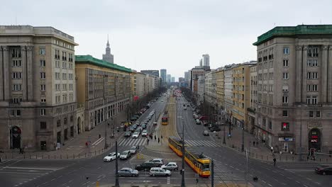 Aerial-drone-view-over-trams-and-buses,-public-transport-in-cloudy-Warsaw,-Poland