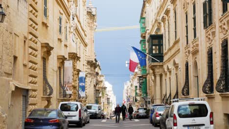 European-flag-hanging-on-majestic-building-of-Valletta,-handheld-view