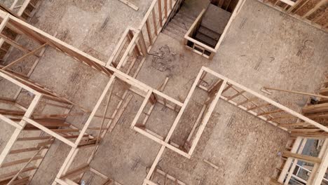Aerial-of-a-house-in-mid-construction,-still-needs-a-roof