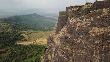 Aerial-flight-to-end-of-Vinchu-Kada-hill-fort-high-above-Indian-farms