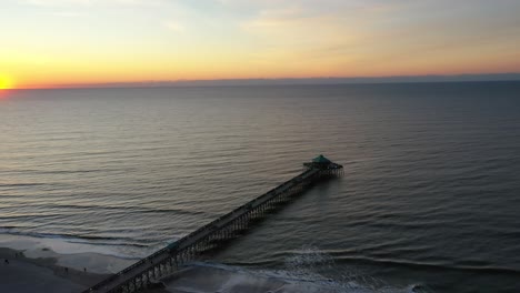 Sunset-Scenery-At-Pier-101-Fishing-Beach-In-South-Carolina,-USA---aerial-drone-shot
