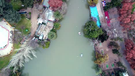 Overhead-aerial-view-of-the-artificial-lagoon-in-O'Higgins-Park-with-pedal-boat-on-the-shore,-Santiago,-Chile