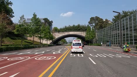 POV-From-A-Car-Driving-Behind-An-Ambulance-Travelling-In-The-City-Of-Seoul,-South-Korea