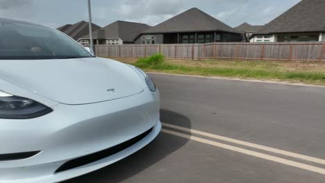 Close-up-tracking-shot-of-Tesla-logo-emblem-on-Model-3-electric-car