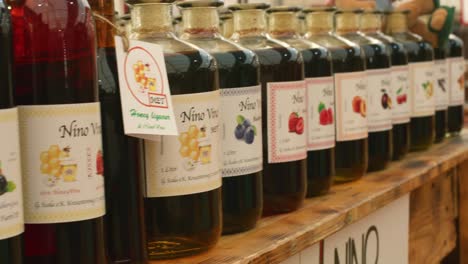 A-variety-of-hand-made-syrups-on-display-at-a-market-in-Stuttgart,-Baden-wurttemberg,-Germany-Europe,-panning-view-angle