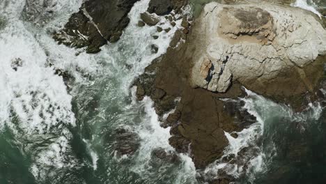 Waves-Crashing-onto-Rocks-on-Pacific-Ocean-Coastline-in-Mexico---Aerial