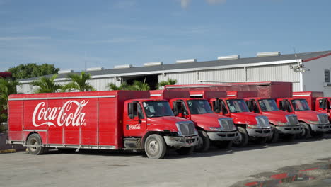 Row-Of-Parked-Coca-Cola-Trucks-At-Distribution-Centre-In-Punta-Cana,-Dominican-Republic