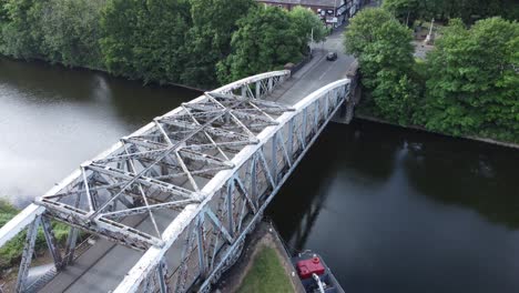Aerial-view-descending-to-cyclist-crossing-Manchester-ship-canal-swing-bridge-Warrington-England