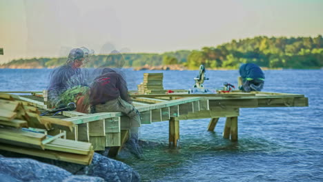 Timelapse-shot-of-workers-building-a-wooden-jetty-over-blue-lake-on-a-sunny-day