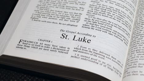 Close-Up-Shot-of-Bible-Page-Turning-to-the-book-of-Luke