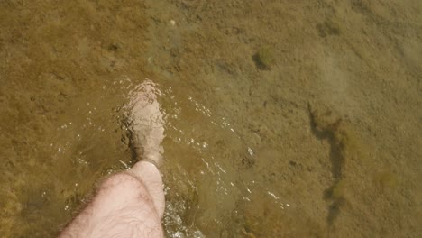 Barefoot-Man-Walking-In-The-Lake-With-Shallow-And-Crystal-clear-Water-At-Summer