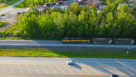 Aerial-view-of-gravel-train-loading-up-with-gravel-as-cameras-passes-along-the-train
