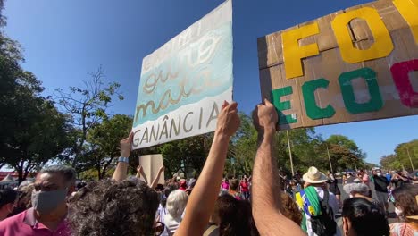 people-at-the-protest-against-the-amazon-killings-of-dom-phillips-and-bruno-pereiro-hold-up-pancardes-with-the-words-gold-and-greed-kills-written-on-them