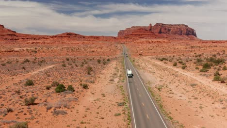 Aerial-view-of-a-truck-towing-a-camper-on-a-long-two-lane-highway-in-Utah