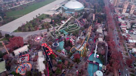 Tilt-down-aerial-view-of-an-amusement-park-with-rides-for-the-whole-family,-Santiago,-Chile