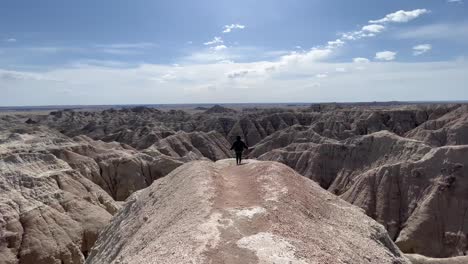 Hiker-young-woman-on-a-overlook-at-Badlands-National-Park