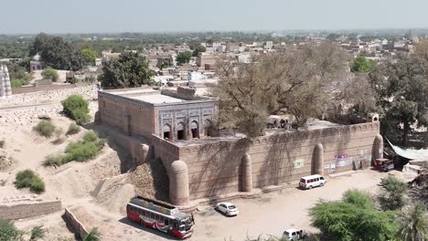 Aerial-Dolly-Back-From-Outside-Wall-Of-Jalaluddin-Bukhari-Tomb-and-Mosque-At-Uch-Sharif