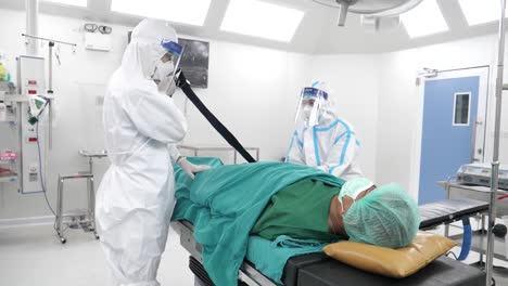Asian-Medical-Staff-Wear-PPE-Prepare-Patient-and-Put-On-Equipment-Before-Surgery