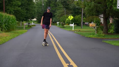 Tall-teenage-boy-skateboard-on-back-road-in-America