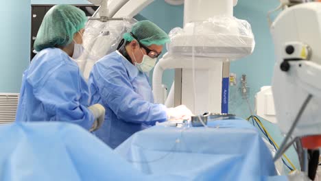 Asian-Surgeon-Wear-PPE-Perform-Surgey-In-Operating-Room,-Close-Up