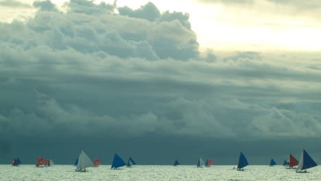 Sunset-in-Boracay-on-a-cloudy-as-sail-boats-speed-on