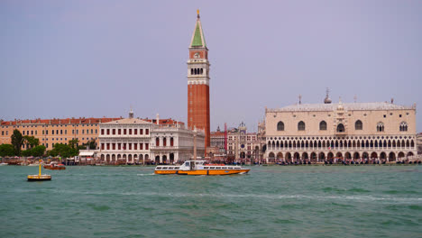 Ferry-Crossing-The-Lido-di-Venezia-In-Front-Of-Saint-Mark's-Square-In-Venice,-Italy---wide