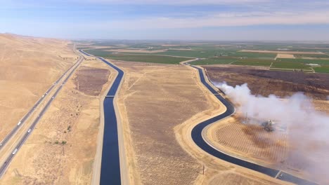 A-burning-wildfire-in-California's-Central-Valley-during-the-dry-season---pull-back-aerial-view