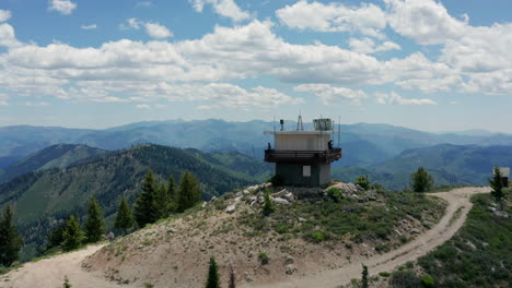 Aerial-passing-manned-fire-lookout-station-in-national-forest