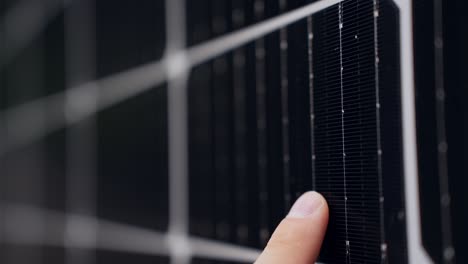 Detail-closeup-of-finger-sliding-on-Solar-Panel-cell-surface-for-inspection