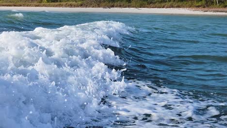 Boat-Wake-Waves-Close-Up-from-Motorboat-Traveling-Next-To-Beach-in-the-Ocean-Current-with-Bubbles-and-Splashing-along-Florida-Seashore