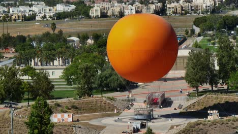 Telephoto-aerial-approach-of-the-Great-Park-Balloon-in-Irvine,-California