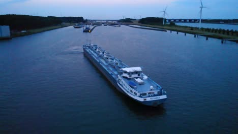 Aerial-View-Over-Minerva-Liquid-Tanker-In-Waterway-Along-Oude-Maas-During-Twilight-Evening-Light