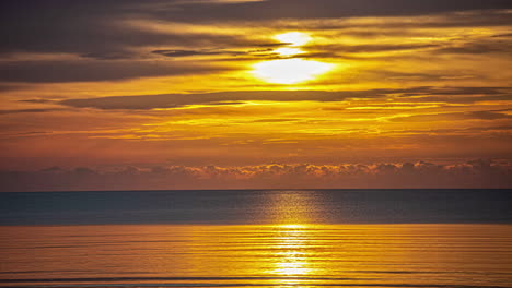 Timelapse-shot-of-majestic-sunrise-throught-he-clouds-over-the-sea
