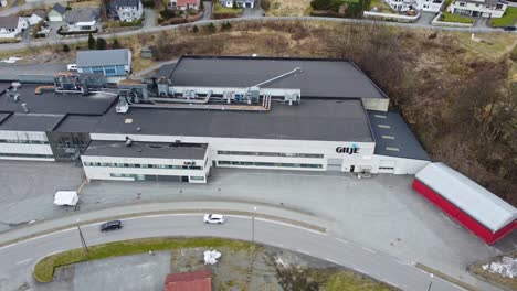 GILJE-door-and-window-factory-in-Moi-Norway---Aerial-rotating-around-factory-and-looking-down-from-birdseye-perspective