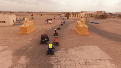 Aerial-shot-following-close-behind-a-group-of-quads-in-the-desert-of-Ouarzazate