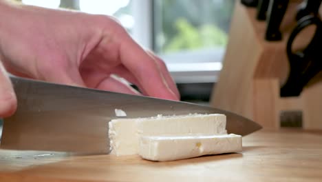 Satisfying-shot-cutting-feta-cheese-into-slabs